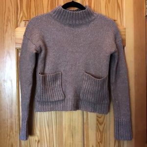 Cropped sweater with deep front pockets.